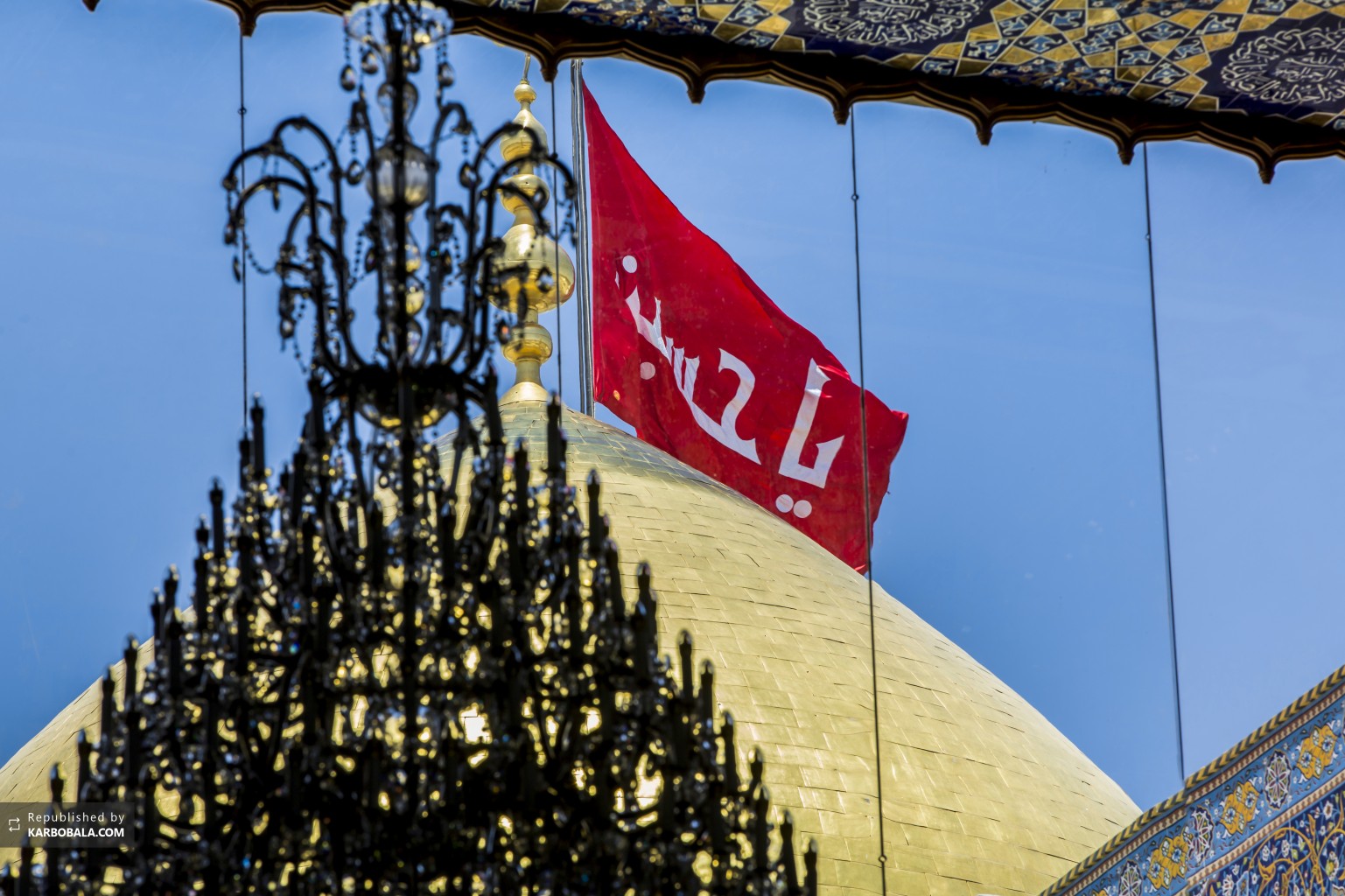 پرچم سرخ حسینی بر فراز گنبد طلا